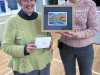 Beryl Webster, winner of the Stitch Competition, is presented with her prize by Joint-Chair Kim at the MEsG Winter Social 2024